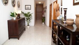 a hallway with a dresser and potted plants at Sant'Anna affittacamere in Alghero