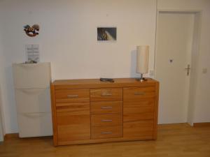 a dresser with a lamp on it next to a refrigerator at Apartment Neuschwändi 66 by Interhome in Engelberg