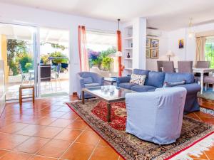 a living room with a blue couch and a table at Holiday Home Esmerdo by Interhome in Estepona