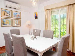 a dining room with a white table and chairs at Holiday Home Esmerdo by Interhome in Estepona