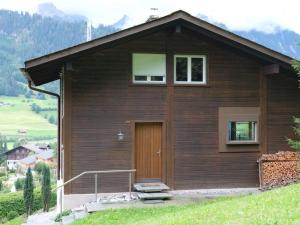 a small house with a door on a hill at Apartment Weidli- Chalet by Interhome in Zweisimmen
