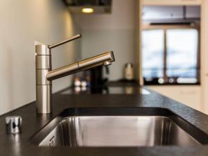 a kitchen sink with a stainless steel faucet at Apartment Apartmenthaus Riederhoru A 1- OG Ost by Interhome in Riederalp
