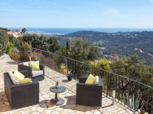a patio with two chairs and a table with a view at Holiday Home Lausanne by Interhome in Calonge