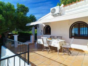 a patio with a table and chairs next to a house at Holiday Home Las Boyas by Interhome in Moraira +25 photos