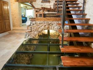 a kitchen with a stone fireplace and a sink at Holiday Home Moulin de Rabine by Interhome in Cancon