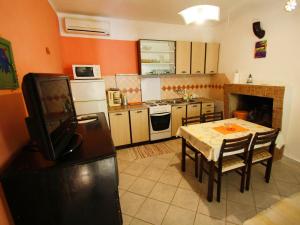 a small kitchen with a table and a refrigerator at Apartment Dijana-1 by Interhome in Prigradica