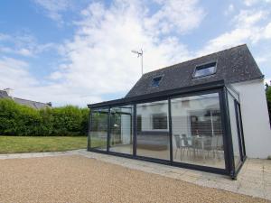 a glass extension of a house with a roof at Holiday Home Zal by Interhome in Saint-Pierre-Quiberon +14 photos