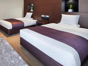 a hotel room with two beds in a room at HOTEL MYSTAYS Shimizu in Shizuoka