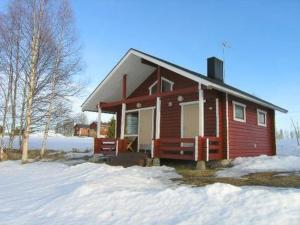 a small red house with snow on the ground at Holiday Home Kallela by Interhome in Jokijärvi