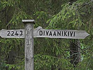 a wooden street sign with the names of two streets at Holiday Home Divaanikivi by Interhome in Pätiälä