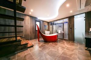 a bathroom with a red tub in the middle at Seosan Aria Hotel in Seosan