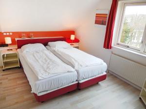 a small bedroom with two beds and a window at Holiday Home Stern Comfort-2 by Interhome in Noordwijk +11 photos
