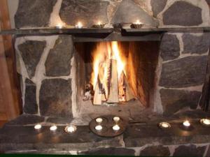 a stone oven with a fire in it at Holiday Home Kopinkallio 1 by Interhome in Vääksy