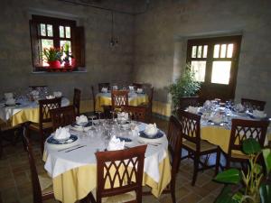 a dining room with tables and chairs with yellow table cloth at Agrituirsmo Masseria Campierti in Falciano del Massico +30 photos