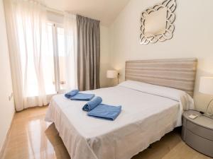 a bedroom with a bed with two towels on it at Apartment Golden Gardens-3 by Interhome in Jávea