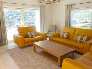 a living room with yellow couches and a coffee table at Villa Belle Vue by Interhome in Cavalaire-sur-Mer