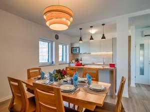 a kitchen and dining room with a wooden table and chairs at Villa Vali 1 by Interhome in Vrbnik