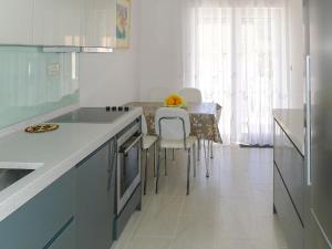 a kitchen with a counter and a table with chairs at Holiday Home Villa Zlatan by Interhome in Stari Grad