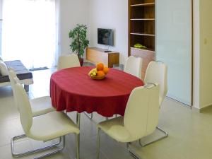 a dining room with a red table and white chairs at Holiday Home Villa Zlatan by Interhome in Stari Grad