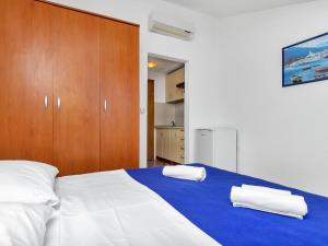 a bedroom with a bed with two towels on it at Apartment Rubin-11 by Interhome in Selca kod Bogomolja