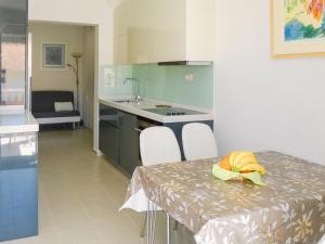 a kitchen with a table and chairs and a kitchen with a counter at Holiday Home Villa Zlatan by Interhome in Stari Grad