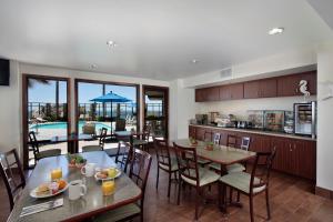 a kitchen and dining room with tables and chairs at Inn at the Cove in Pismo Beach