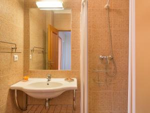 a bathroom with a sink and a shower at Holiday Home Grand Beach Hit by Interhome in Pêra
