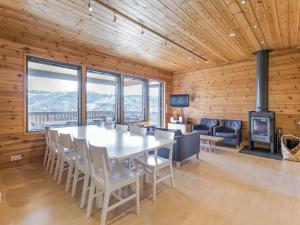 a dining room with a table and chairs and a fireplace at Holiday Home Ameno 2 by Interhome in Jämsä