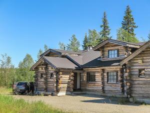 a log cabin with a car parked in front of it at Holiday Home Kantapää d2 by Interhome in Luosto