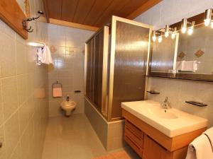 a bathroom with a sink and a shower and a toilet at Residence Rottonara in Corvara in Badia +61 photos