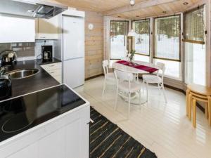 a kitchen and dining room with a table and chairs at Holiday Home Hästöskata a by Interhome in Kruunupyy