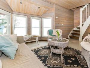 a living room with a couch and a table at Holiday Home Hästöskata a by Interhome in Kruunupyy