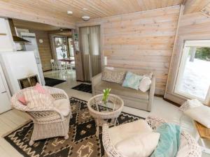 a living room with wicker chairs and a couch at Holiday Home Hästöskata a by Interhome in Kruunupyy