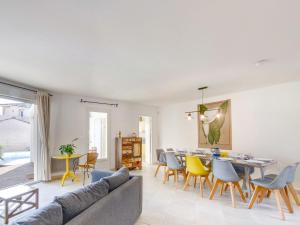 a living room with a couch and a table and chairs at Villa Villa Perdrix by Interhome in La Palud