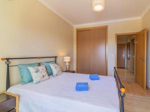 a bedroom with a large white bed with blue pillows at Apartment Monte da Eira by Interhome in Brejos +7 photos