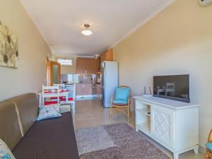 a living room with a couch and a tv and a kitchen at Apartment Monte da Eira by Interhome in Brejos