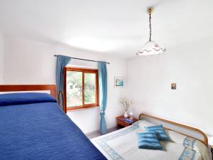 En eller flere senge i et værelse på Apartment Terrazza Cala Rossa by Interhome