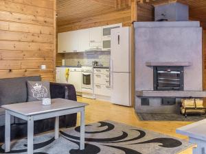 ein Wohnzimmer mit Tisch und Kamin in der Unterkunft Holiday Home Kiehislevi a by Interhome in Levi