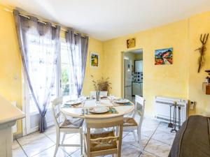 a kitchen and dining room with a table and chairs at Holiday Home Les Grillons by Interhome in Saint-Palais-sur-Mer
