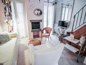 a living room with white furniture and a fireplace at Holiday Home Carlotta by Interhome in Soviore