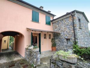 an external view of a house with a stone wall at Holiday Home Carlotta by Interhome in Soviore