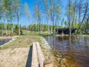 a house in the middle of a body of water at Holiday Home Runopuro by Interhome in Kerkonjoensuu