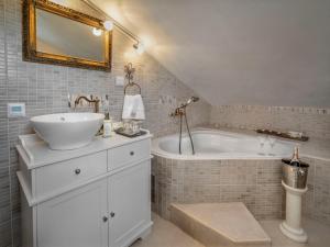 a bathroom with a sink and a bath tub at Holiday Home Villa Aurora by Interhome in Loborika