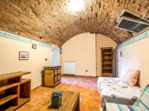 a living room with a couch and a table at Apartment La Fonte by Interhome in Volterra