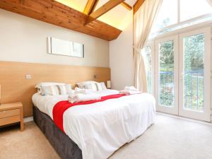a bedroom with a large bed and a large window at Holiday Home The Valley by Interhome in Perranwell