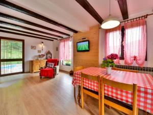 a dining room with a table and a tv at Holiday Home Božica by Interhome in Brod na Kupi +28 photos