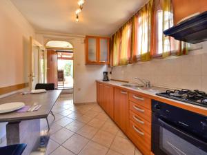 a kitchen with a sink and a stove at Apartment Lidija by Interhome in Matulji