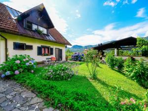 a house with a garden in front of it at Holiday Home Božica by Interhome in Brod na Kupi