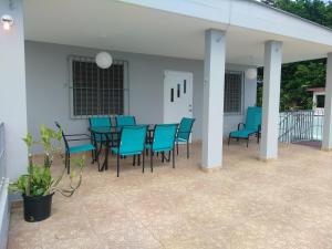 a patio with blue chairs and a table on a patio at Urban Terrace Apartment in San Juan in San Juan
