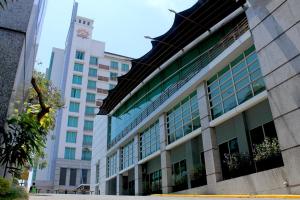 a large building with windows on the side of it at Grand Surya Hotel Kediri in Kediri